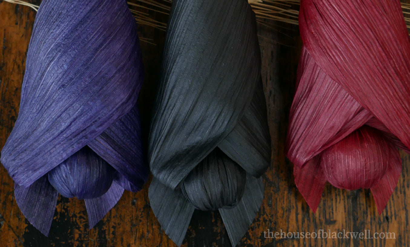 Baby bat trio corn husk dolls, Red, black, and purple